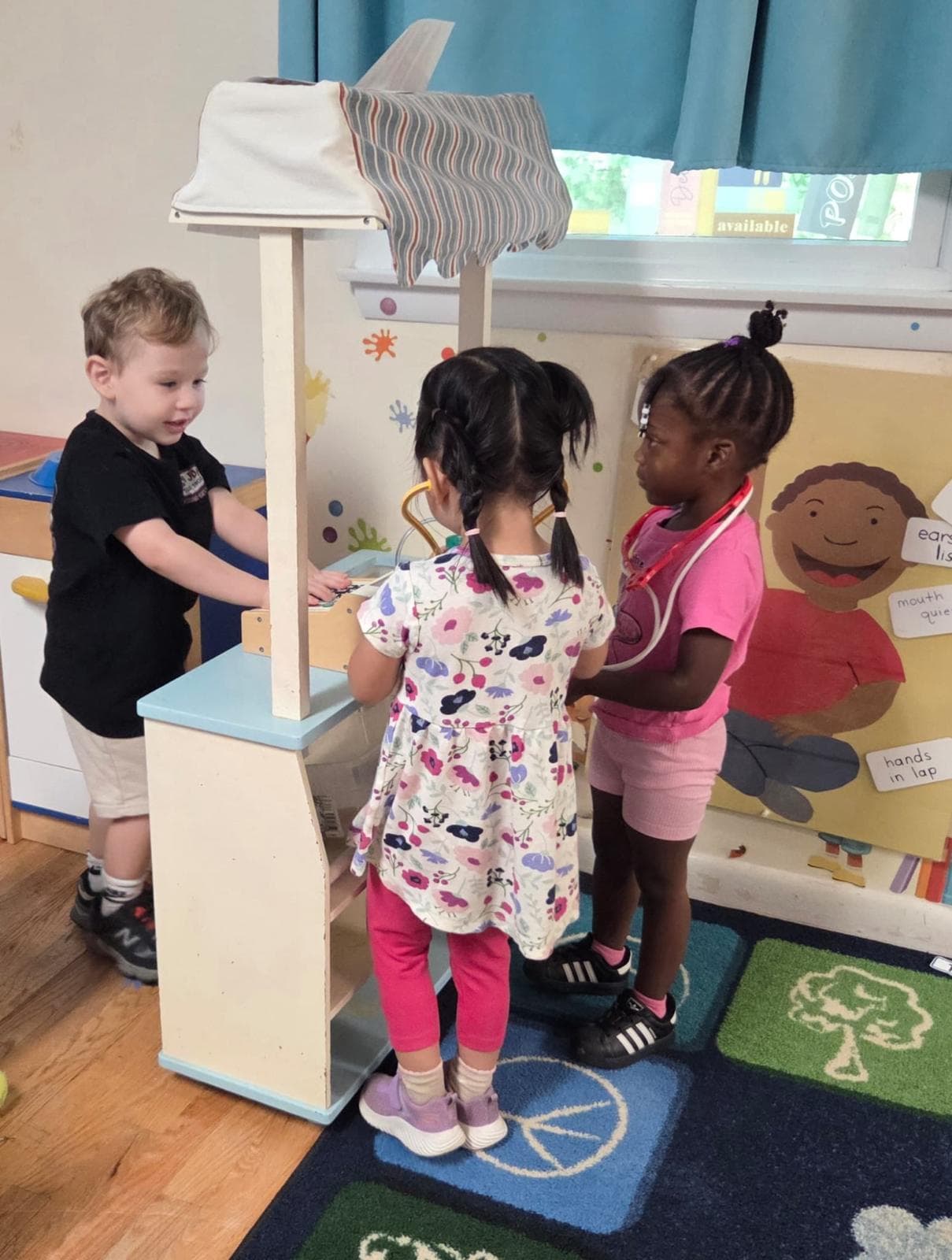 Children playing shop and doctor together in the classroom